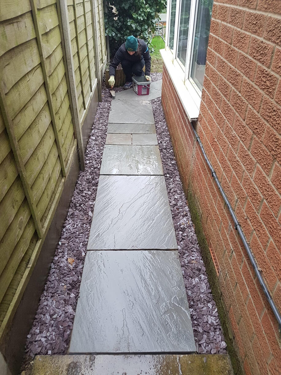 Paving and laying slate.