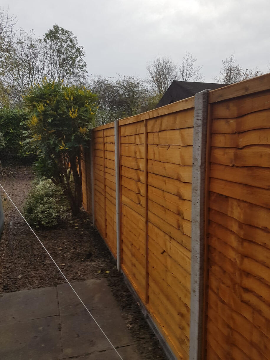 Installation of a concrete post fence.